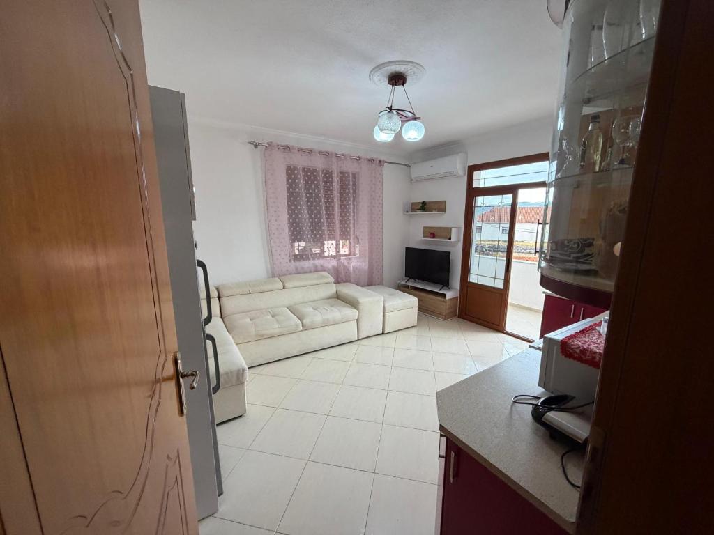 a living room with a couch and a table at Cozy Pogradec in Pogradec
