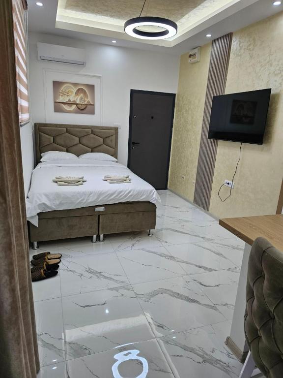 a bedroom with a bed and a tiled floor at Studio centar Lazic 1 in Šid