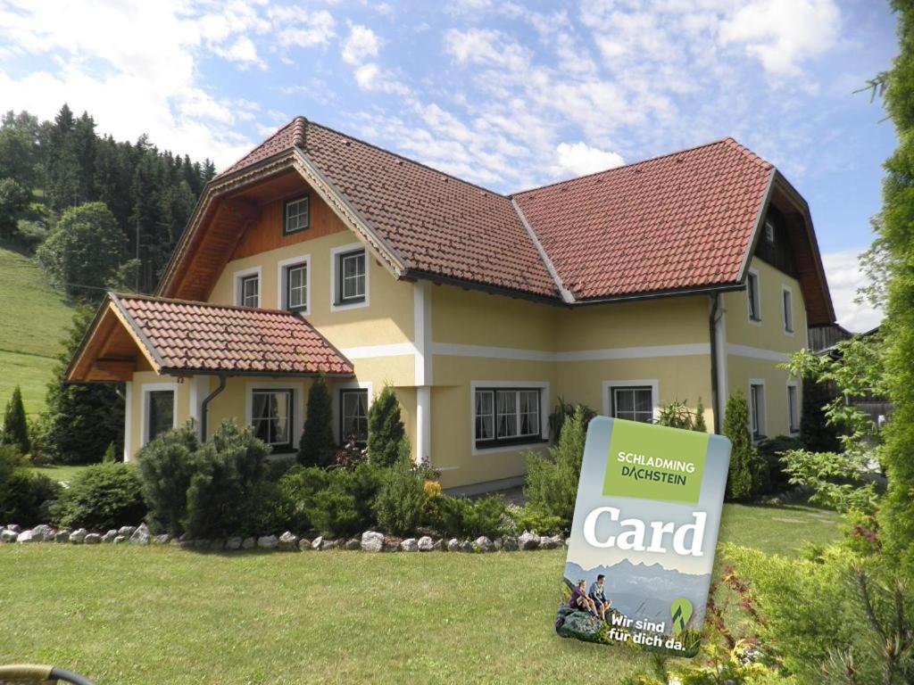 a house with a sign in front of it at Bio-Landhaus Kesslerhof in Gröbming
