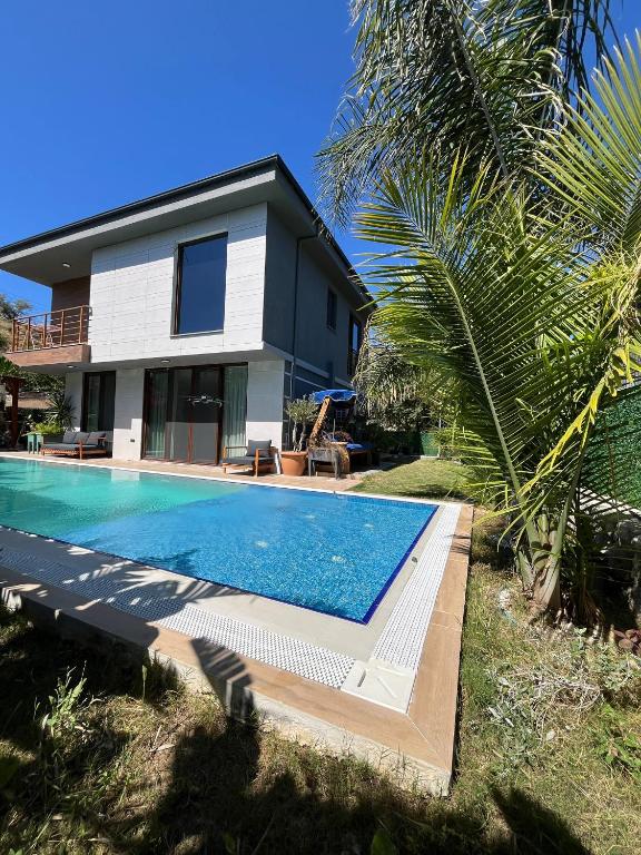 a house with a swimming pool in front of a house at Villa Sunset in Marmaris