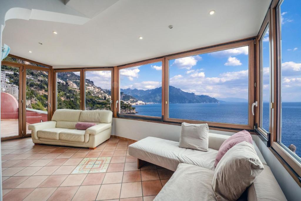 a living room with a view of the ocean at Il Sogno Costa d'Amalfi in Conca dei Marini