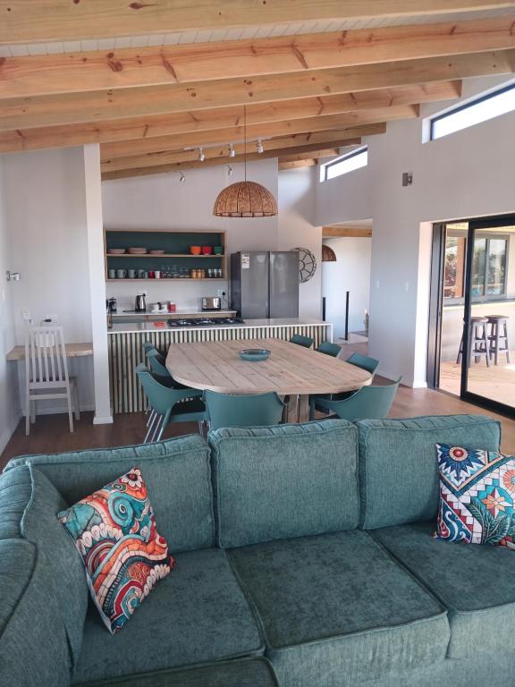 a living room with a couch and a table at Seals Tides - sleeps 12 in Cape St Francis