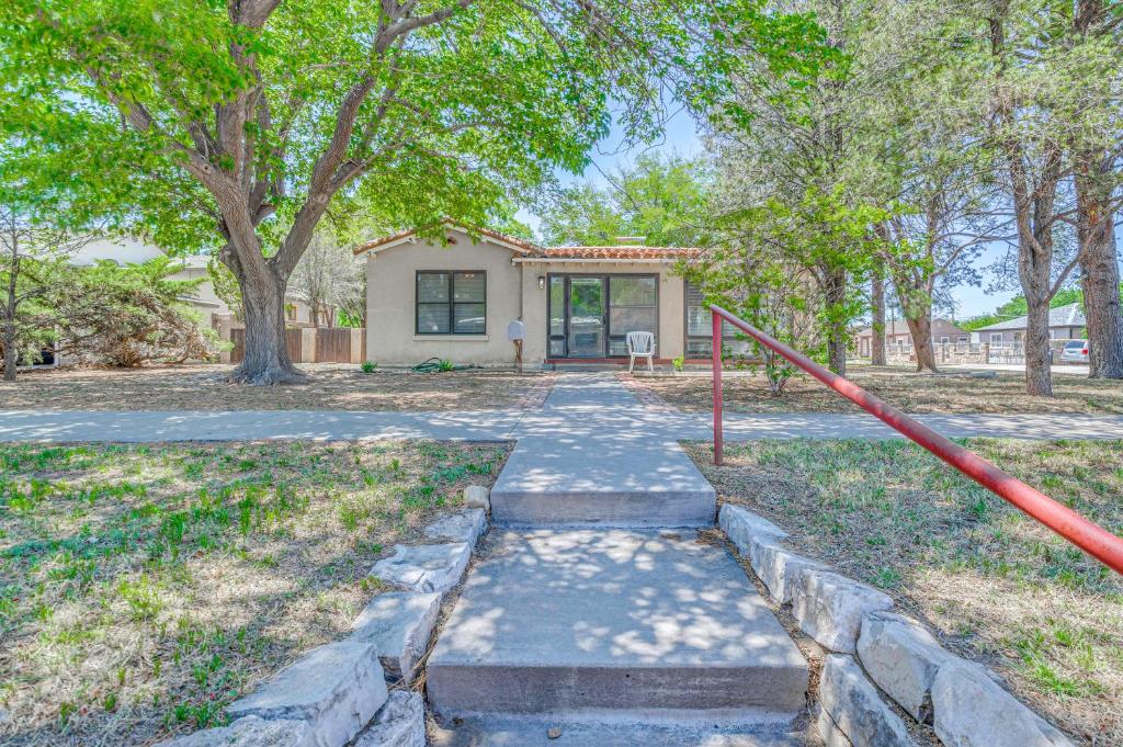 a home with a pathway leading to a house at Highly Walkable Area! Charming Roswell Bungalow in Roswell