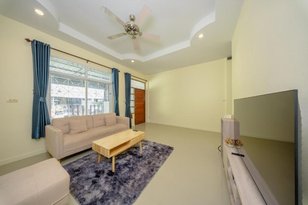 a living room with a couch and a table at Nan's 2 Bedroom House in Krabi