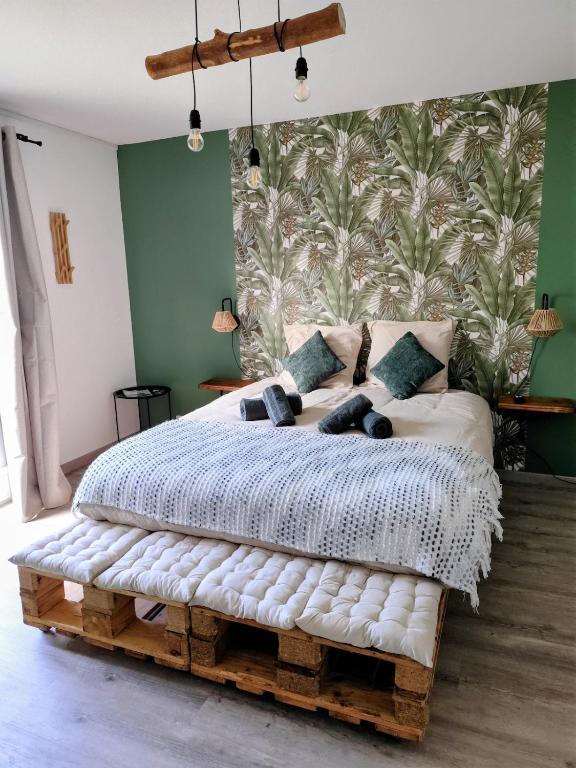 a bedroom with a bed made out of logs at L'Orée du Bois in Pulnoy