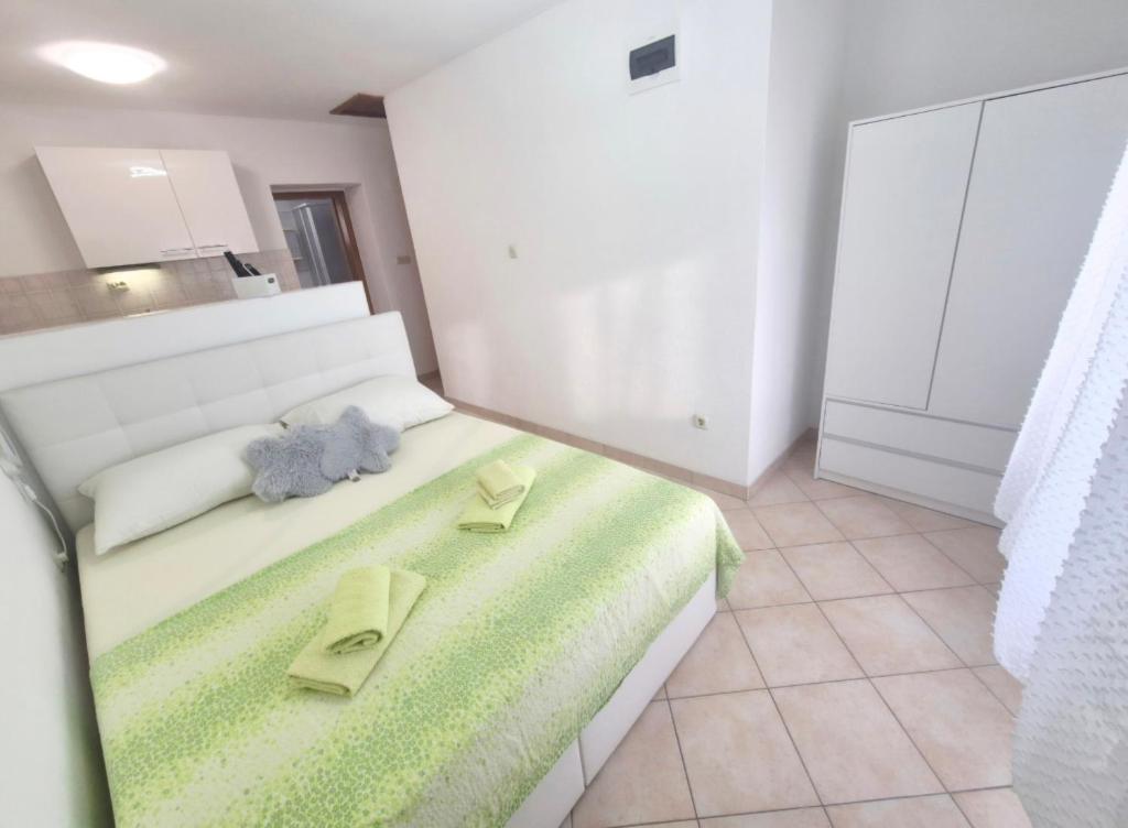 a bedroom with a bed with two towels on it at Apartments Mate in Komiža