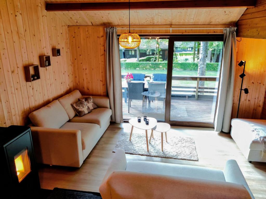 a living room with a couch and a table at Chalet La Roche 231 in Rendeux
