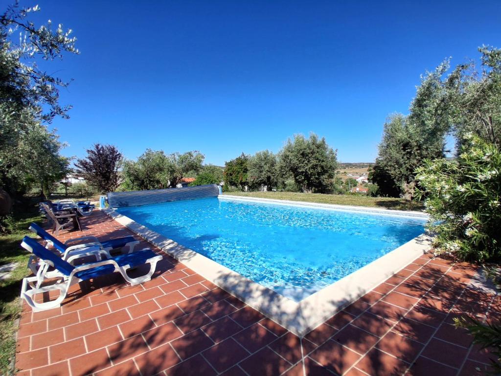 a swimming pool with two lounge chairs next to it at Casa De Terena in Terena
