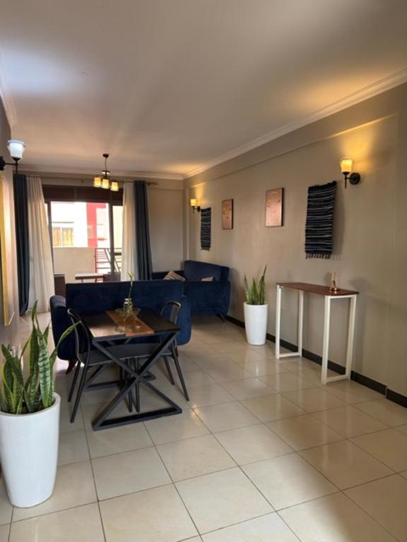 a living room with a table and a couch at Carihaven Homz Najjera in Buwate