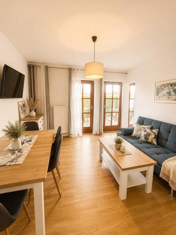 a living room with a blue couch and a table at Apartment Harbach in Harbach