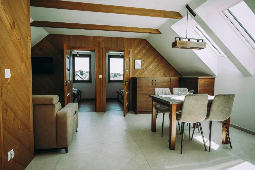 a dining room with a table and chairs at Apartament CEKO 2 in Ostrowsko