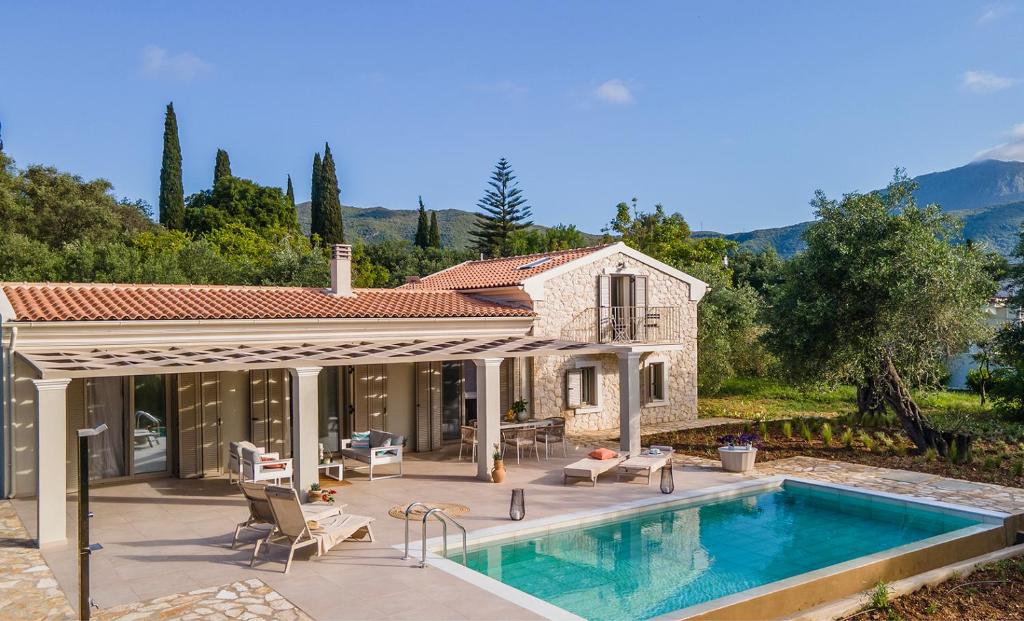 a villa with a swimming pool and a house at Villa Oliva with Private Pool by Konnect in Kato Korakiana