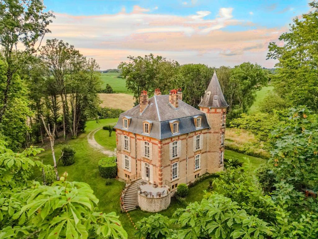 an aerial view of an old castle in a field at Private Château with sauna, hot tub & 4ha park - Château Guillermo in La Moncelle