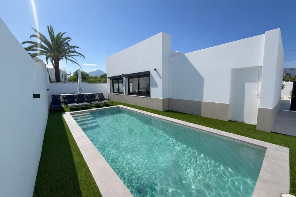 a swimming pool in the backyard of a house at Villa Jupiter by Albir Proper Properties in Albir