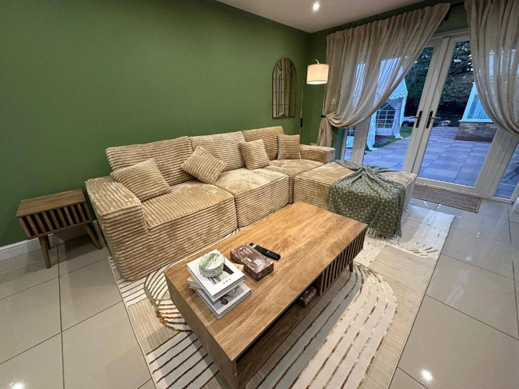 a living room with a couch and a coffee table at Stylish 2 Bed Flat Parking Sutton Coldfield in Birmingham