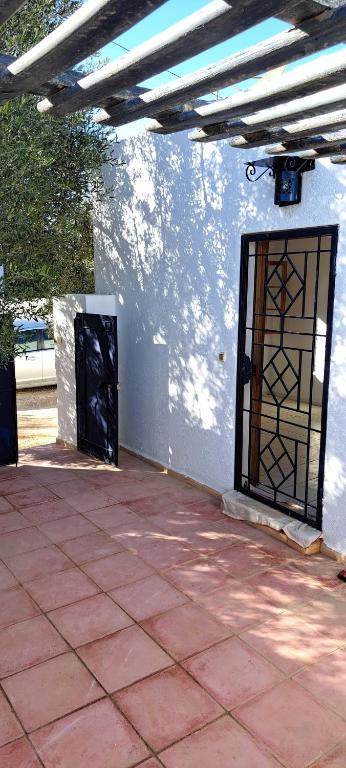 a patio with two doors on a white wall at Dar Mnasri in Houmt Souk