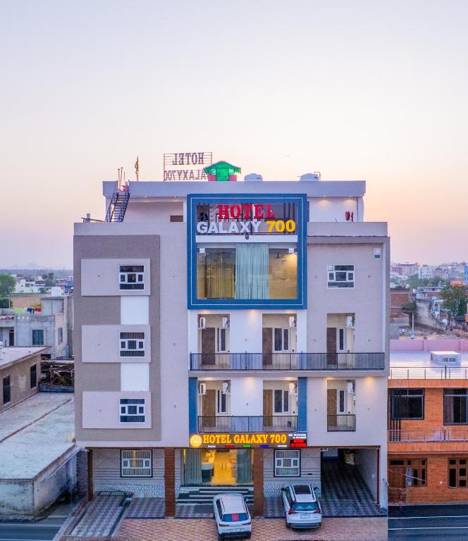 a building with cars parked in front of it at Hotel Galaxy 700 - A Luxury Hotel Near KhatuShyamJi Temple in Khātu