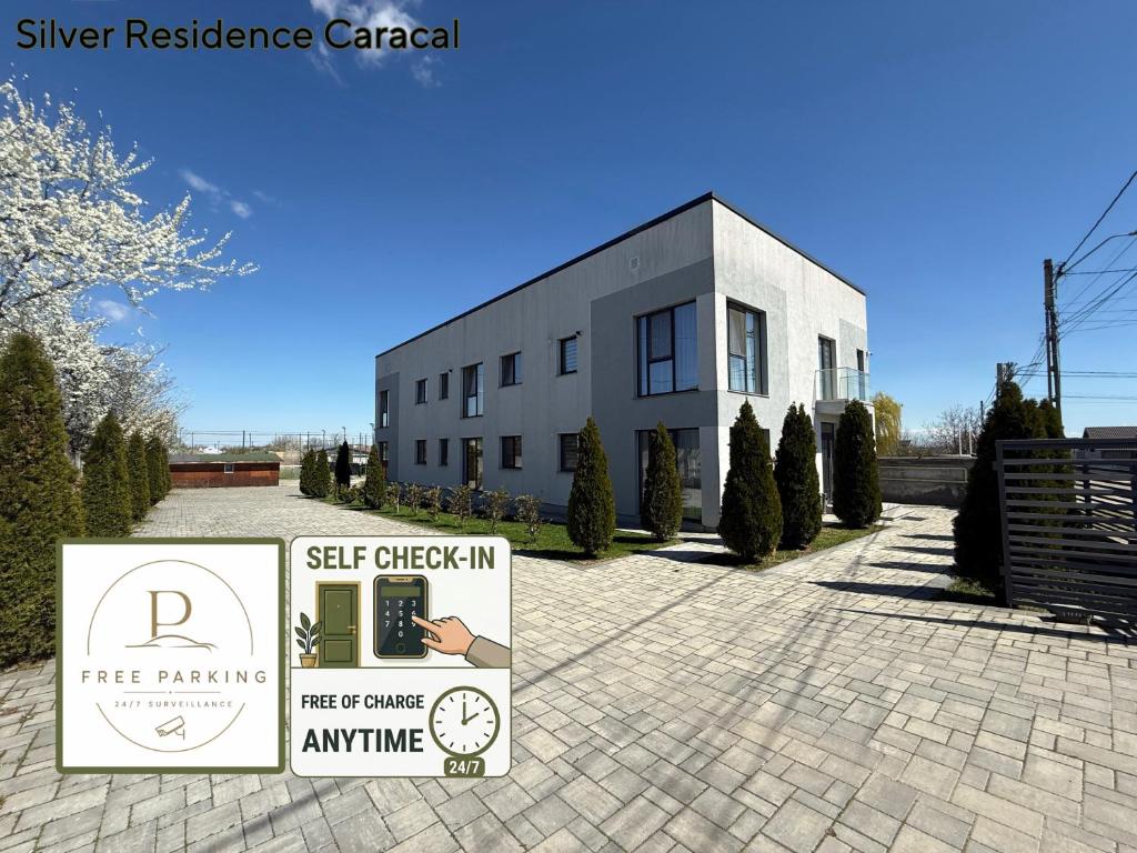 a building with a sign in front of it at Silver Residence Caracal in Caracal