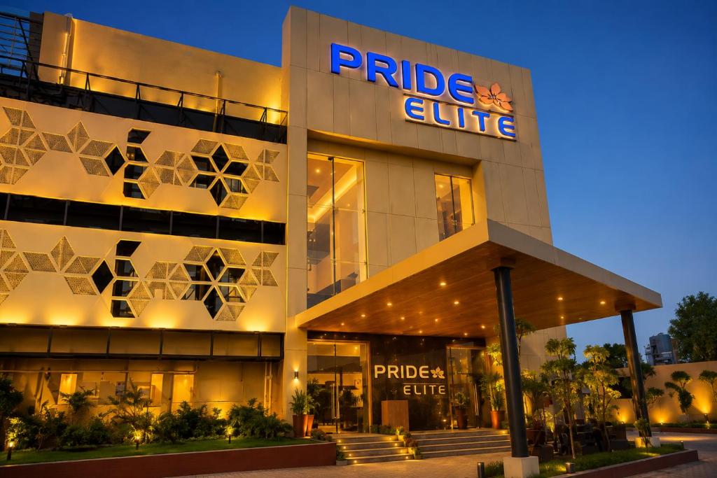 a building with a purple cube sign on it at Pride Elite Himmatnagar in Sonāsan