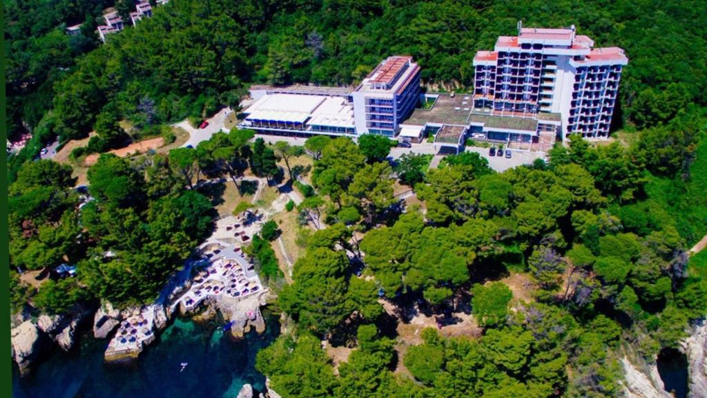 an aerial view of a building on a hill next to the water at CORPUS A - Hotel Albatros in Ulcinj