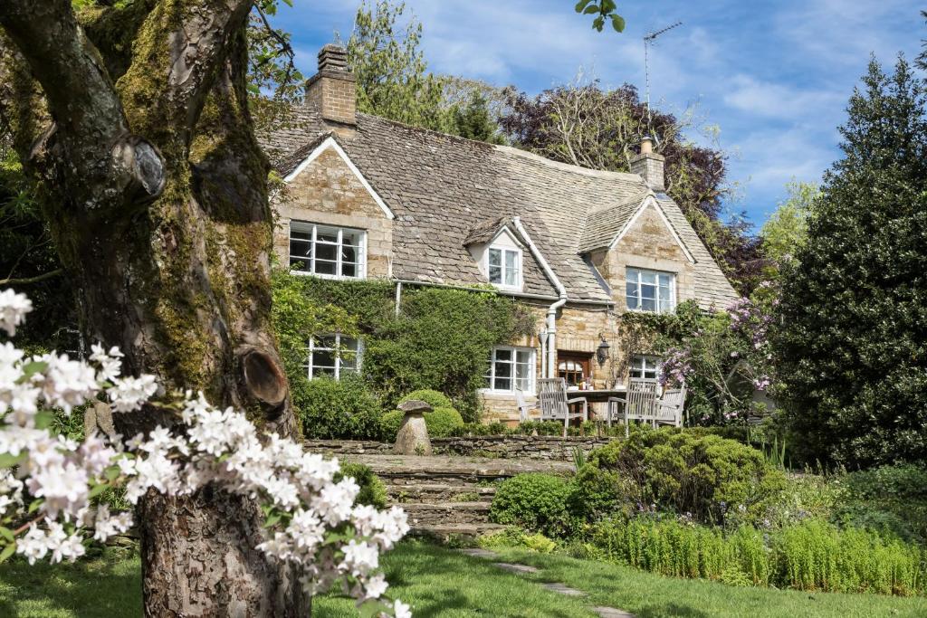 a house with white flowers in front of it at Top Cottage, Oddington in Adlestrop