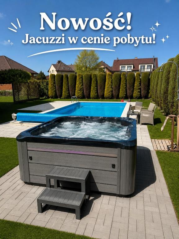 a hot tub with a bench in a yard at Riviera -ADULTS ONLY in Rewal