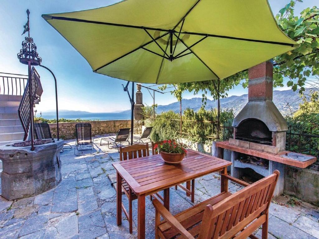 a patio with a table and an umbrella at Apartment Tijan in Kastav