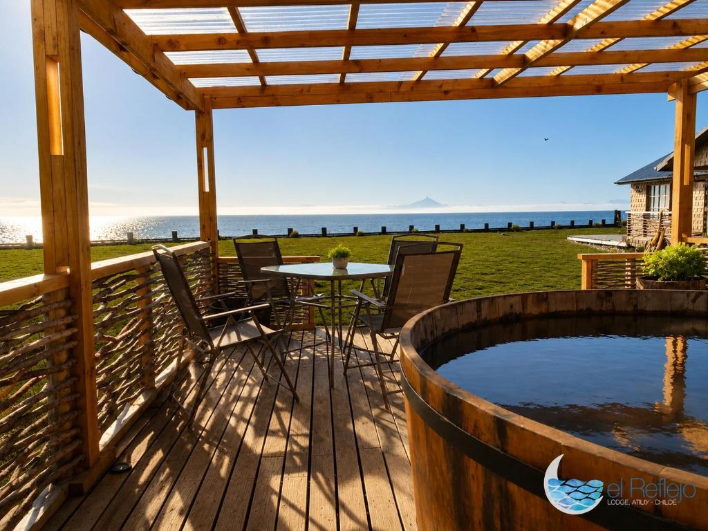 a deck with a table and chairs and a hot tub at El Reflejo Lodge Spa - Queilen - Chiloé in Queilén