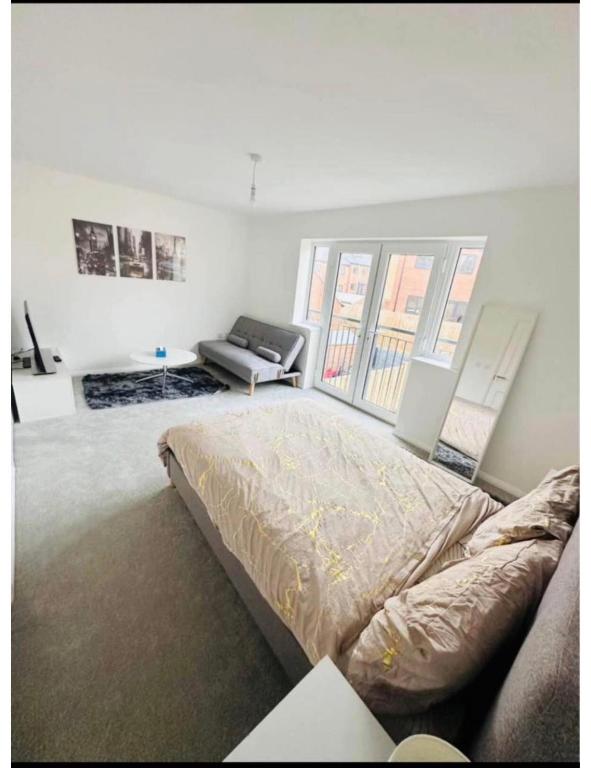 a bedroom with a bed and a couch in it at Ansari House in Dummer