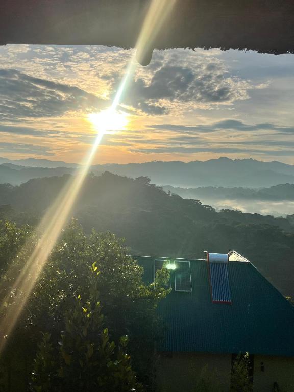 a view of the sun setting over the mountains at Bwindi Neckview Lodge in Buhoma