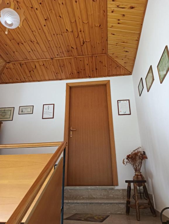 a hallway with a wooden door and wooden ceiling at Carpineti Republic in Monterone