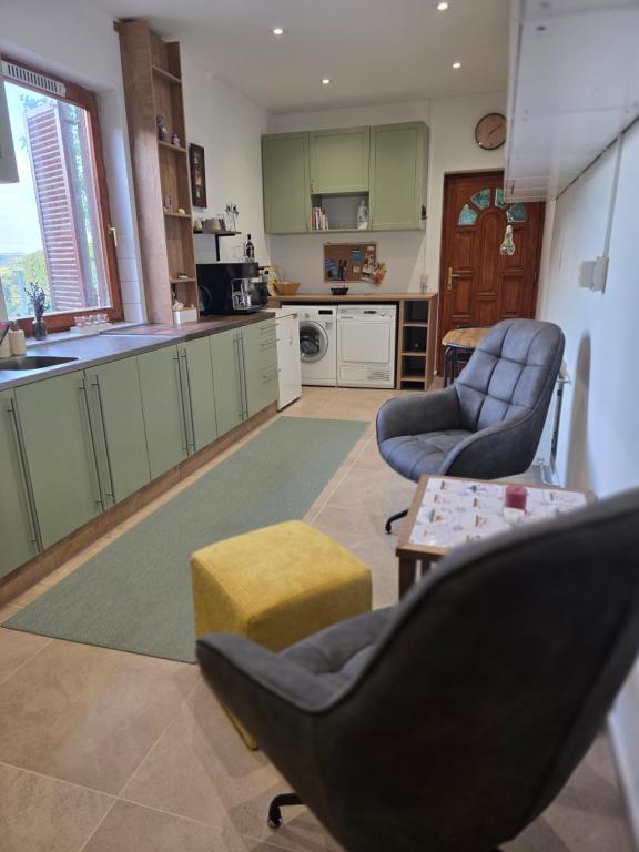 a kitchen with two chairs and a table at Hillside Home in Magyarhertelend