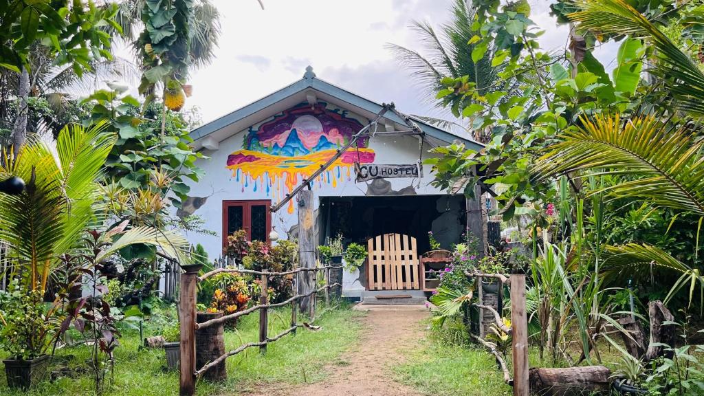 a house with a painting on the side of it at C U Hostel in Trincomalee