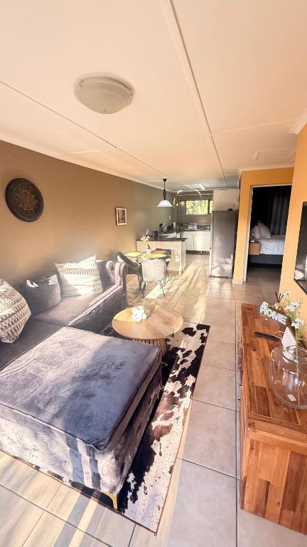 a living room with a couch and a table at 2 Bedrooom Self Catering Unit, East London, 5241, South Africa, KuGompo City in Dorchester Heights 