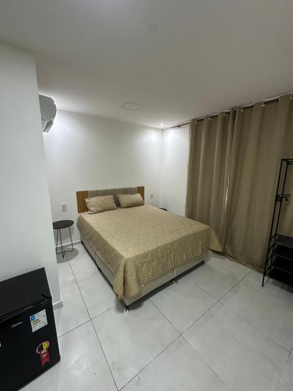 a bedroom with a bed in a white room at Villa Marechais in Marechal Deodoro
