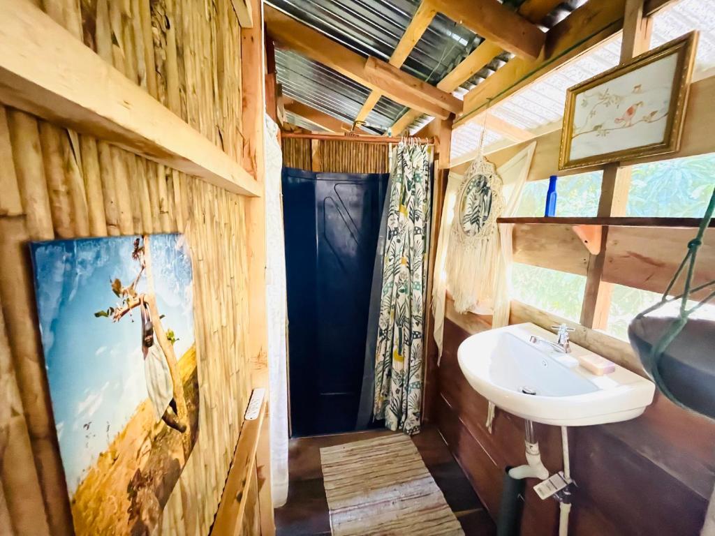 a bathroom with a sink in a log cabin at Cedar Loft in Las Pilas