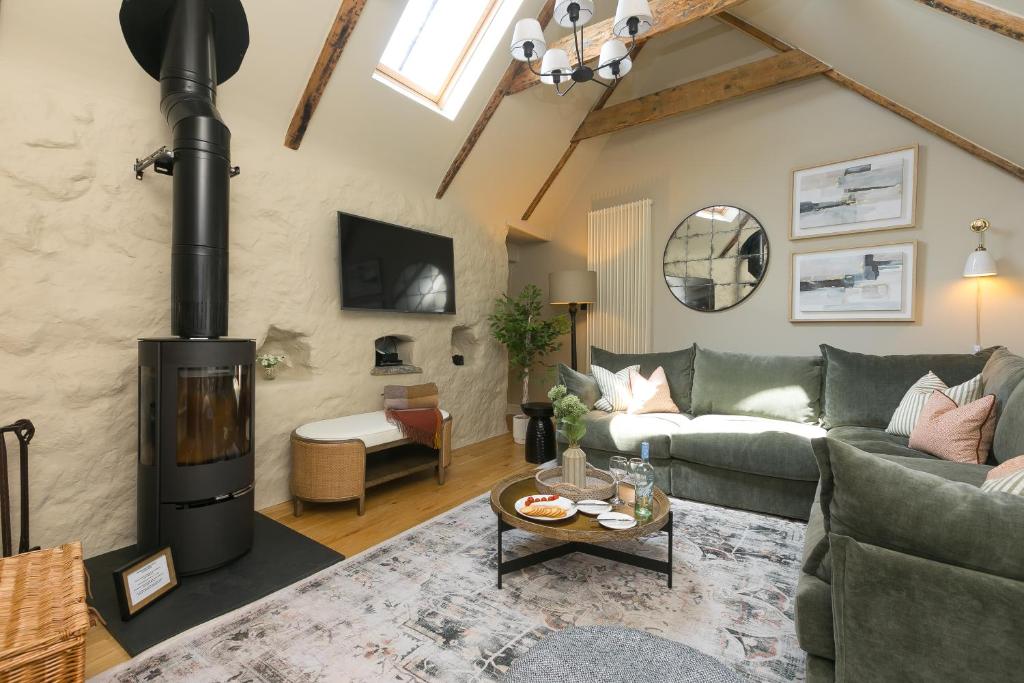 a living room with a couch and a fireplace at The Moorings in St Ives