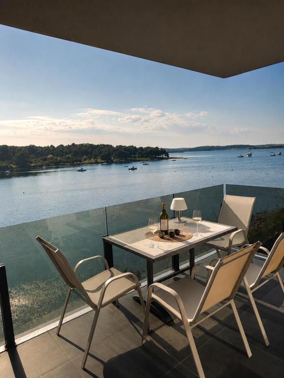 a table and chairs with a view of the water at Apartment ALBA in Medulin
