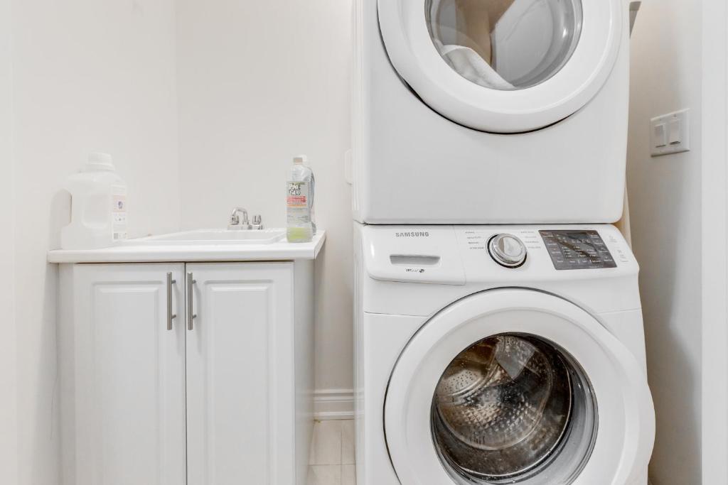 a white washer and dryer in a bathroom at Spacious Bright Private! Townhome in Markham in Markham