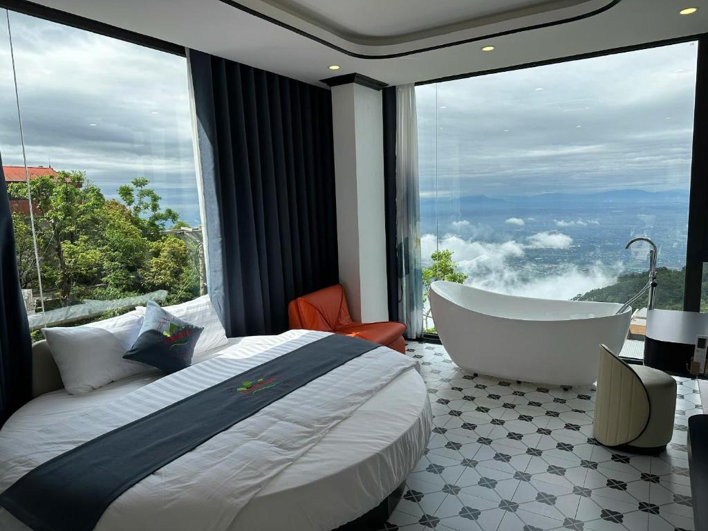 a bedroom with a bed and a bath tub and a window at Time Villa in Tam Ðảo