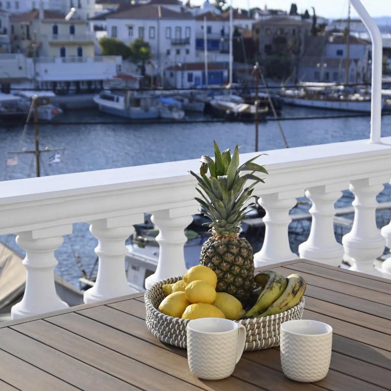 a basket of fruit sitting on a table on a balcony at Anezo's Exceptional View in Spetses