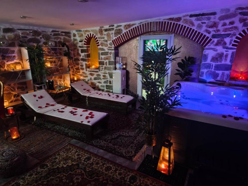 a living room with a hot tub in a room at Giorgos Suite - Jacuzzi Hideaway in Lydia, Kavala in Lidia