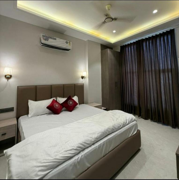 a bedroom with a large bed with red pillows at Hotel sky inn in Jalandhar
