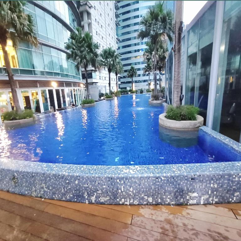 a large blue swimming pool in a building at vortex klcc by IOI HOME management in Kuala Lumpur