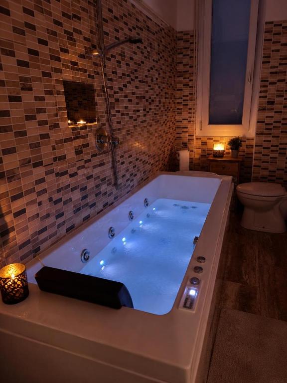 a bath tub in a bathroom with a toilet at Easy Room Italy Central Station in Milan