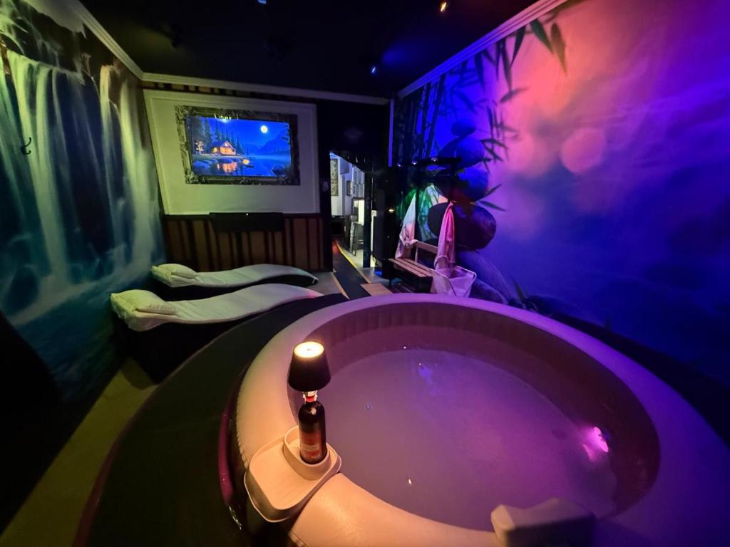 a bathroom with a bath tub with a tv in it at Kandinsky CASA VACANZE Relax in Monterosso Almo