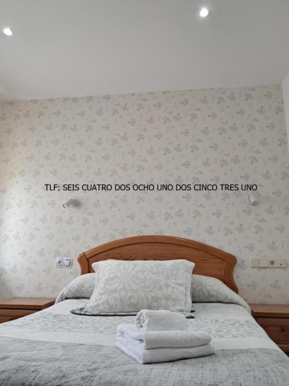 a bedroom with a bed with two towels on it at La orilla del sella in Cangas de Onís