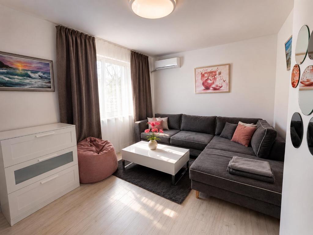 a living room with a couch and a table at Sweet Escape Varna in Varna City