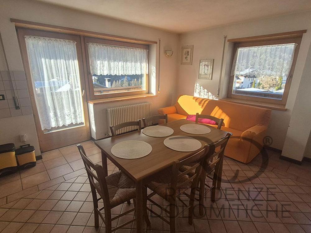 a living room with a table and chairs and a couch at Villa Clelia in Auronzo di Cadore