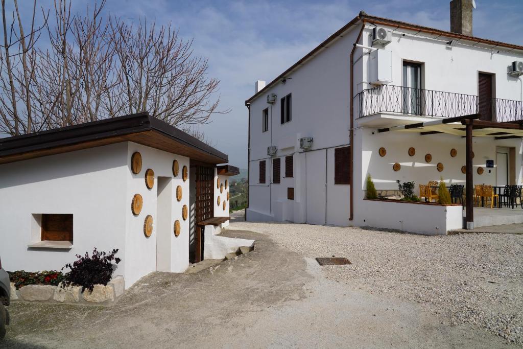 a white building with a balcony on the side at B e B LEMI in Ponte